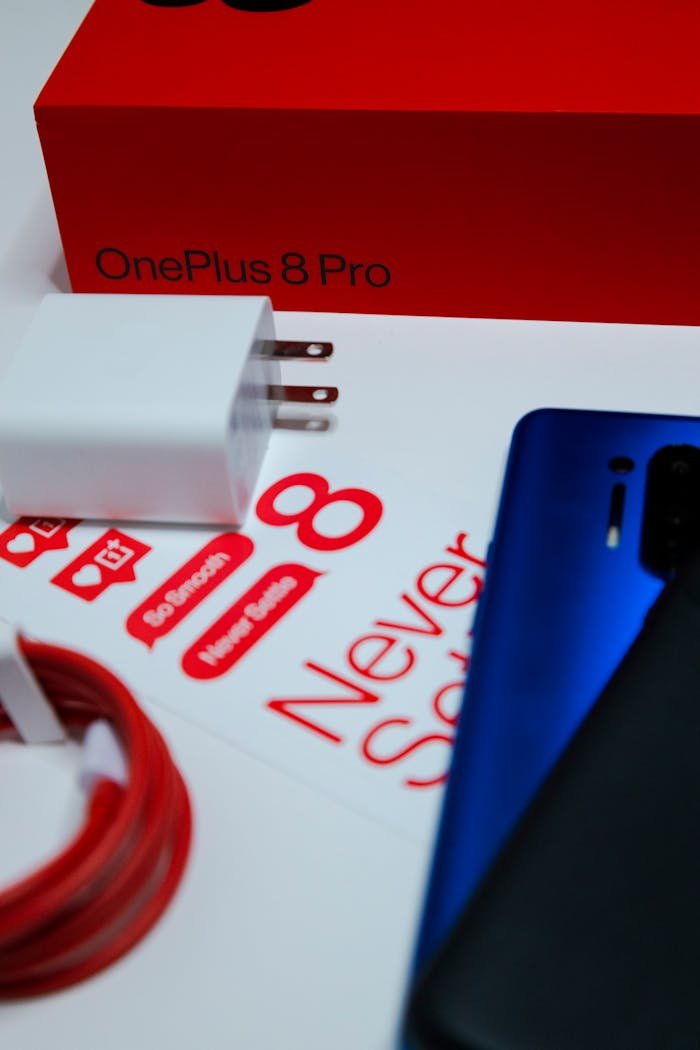 Close-up of OnePlus 8 Pro phone, charger, and packaging for an unboxing experience.